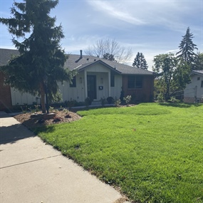 Renovated Edina front yard with new mulch, trimmed plantings, and restored lawn