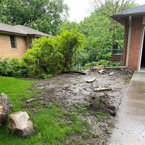 Muddy construction-damaged side yard before landscape renovation in Edina, MN