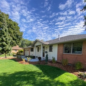 Completed front landscape renovation with refreshed mulch beds and trimmed shrubs