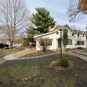 Curved paver walkway wrapping around landscaped beds at a Buffalo, MN property
