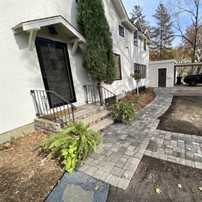 Belgard paver walkway installed beside the front entry and landscaped garden bed