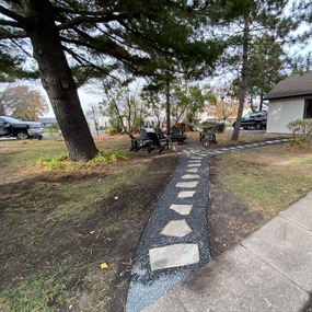 Flagstone pathway set in crushed granite leading through a residential side yard