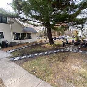 Curved flagstone stepping-stone path connecting outdoor spaces at a Buffalo, MN home