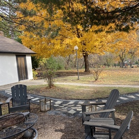 Flagstone pathway connecting a backyard seating area and fire pit space