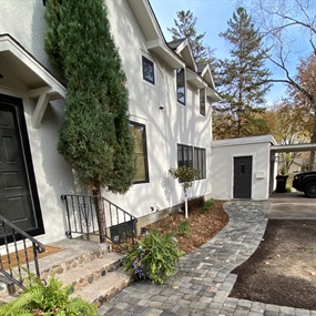 Belgard paver walkway connecting the front entrance, driveway, and detached garage