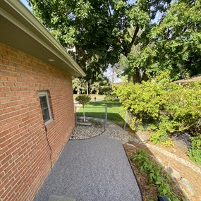 Finished crushed granite walkway providing firm access along the side of the home